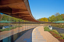 The gently curving arc of the new addition seen in this photo reflects back to the iconic Meeting House. - Photo Credit: The Kubala Washatko Architects, Inc. / Zane Williams