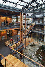 Workspaces surround the interior atrium "Commons." - Photo Credit: Benjamin Benschneider