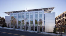 North elevation from Ridge Road: The north elevation faces the community with a calmer façade. Large north-facing windows welcome the daylight and reveal the activities within. A narrow landscaped zone along the street frontage filters 100% of roof drainage from the project. - Photo Credit: Tim Griffith