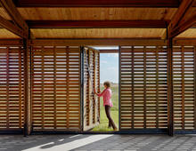 The sliding, wood slat doors also have operable panels. - Photo Credit: Casey Dunn
