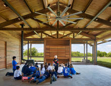 School children sit in the education center but are still connected to the outdoors. - Photo Credit: Dror Baldinger