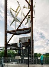 Wind turbines work in concert with photovoltaic panels above to achieve net zero facility energy balance. - Photo Credit: Photography by Joe Fletcher